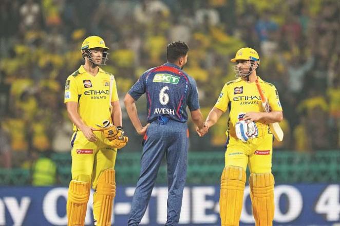 Lucknow Supergiants` Owais Khan congratulates Mahendra Singh Dhoni. Photo: INN