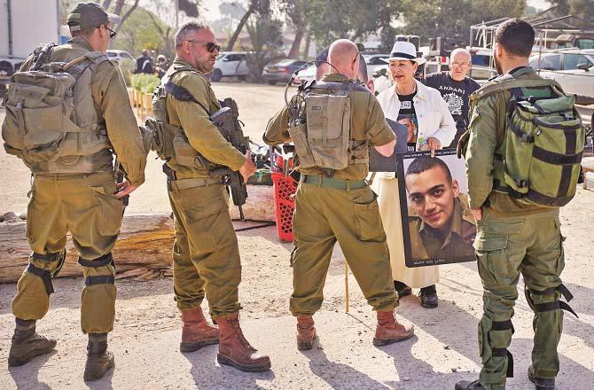 Varda Ben-Baruch protests in northern Israel with a picture of her grandson, Yaden Alexander. Photo: AP/PTI
