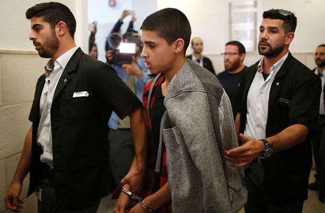 Ahmad Manasra can be seen among Israeli police officers. Photo: INN.