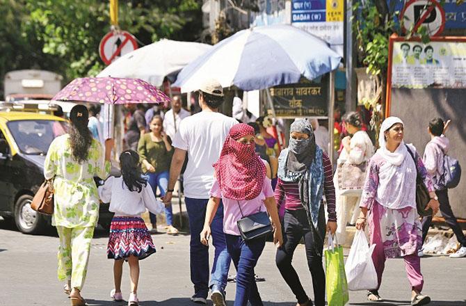 Cover your head and face when leaving the house, and use an umbrella to protect yourself from the sun. Photo: Ashish Raje