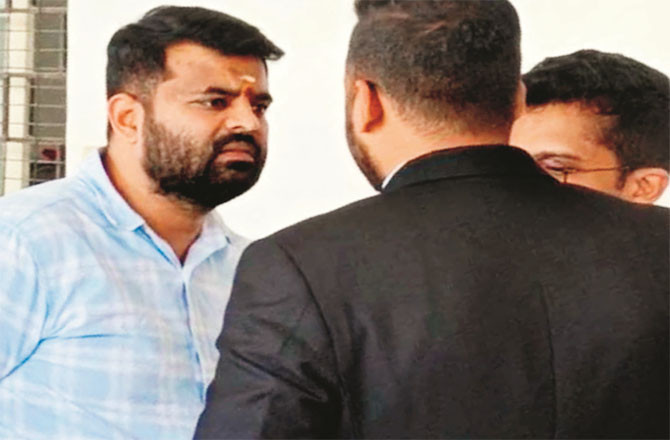 Prajwal Revanna  interacting with lawyers inside the court premises.
