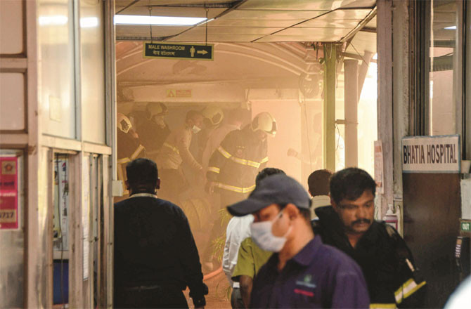 Firefighters trying to put out a fire at Bhatia Hospital