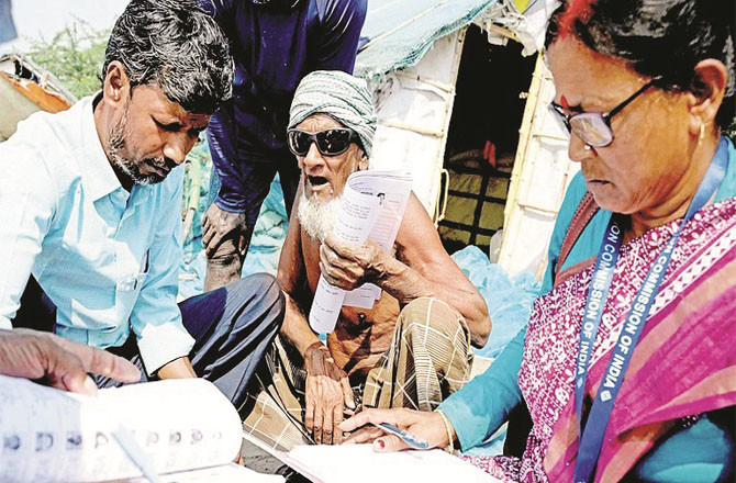 Signs of curiosity and concern are evident on the faces of citizens with SIR.