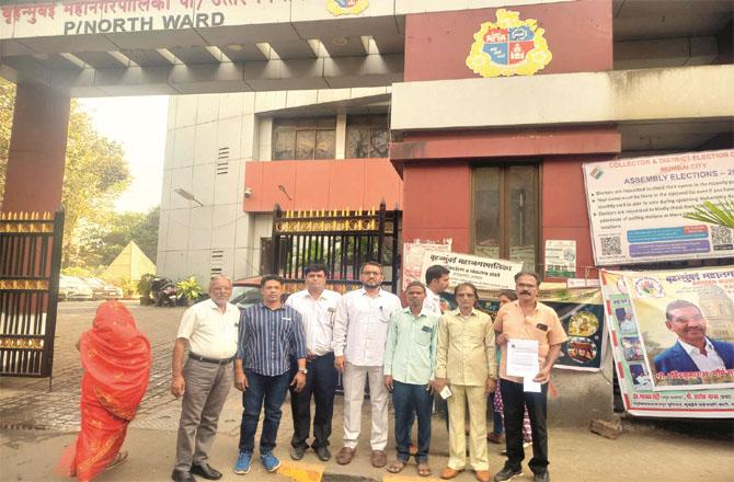 Members of the Maloni Vikas Manch delegation are seen standing outside P North Ward.