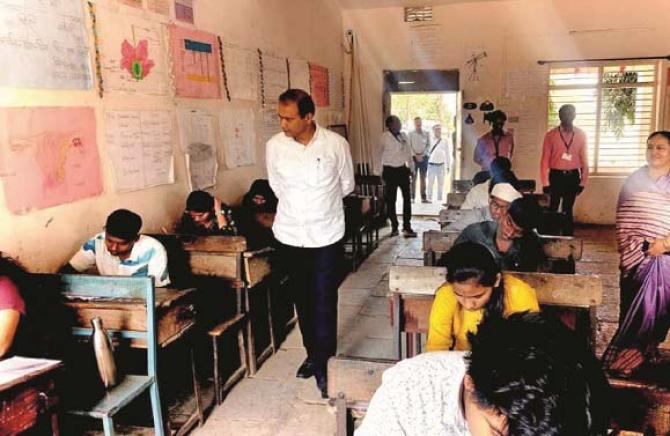 Minister Pankaj Bhoyar is watching the students writing papers. Photo: INN