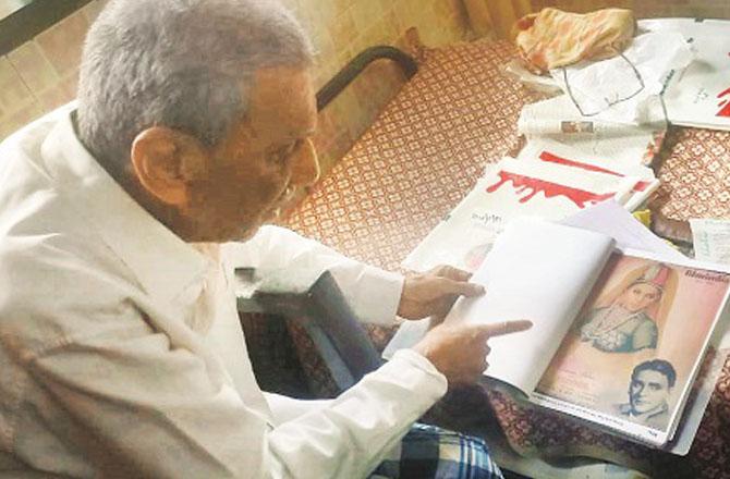 Muhammad Usman Ghani showing off rare treasures, including cassettes, records, and files of news and film magazine clippings. Photo: INN