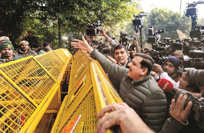 Sanjay Singh and Saurabh Bhardwaj stand in front of the barricade set up by the police.  Photo: PTI