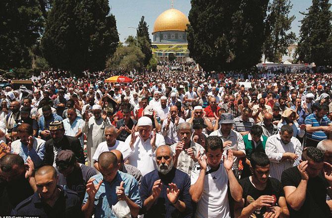 A scene of prayer at Al-Aqsa Mosque, with the Dome of the Rock visible in the background. File photo