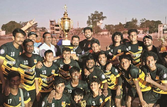 Players of Mominpura`s young boys football team with the cup after winning the tournament. Photo: INN