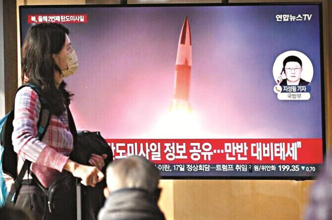 A woman watches a news channel about a ballistic missile test. Photo: INN