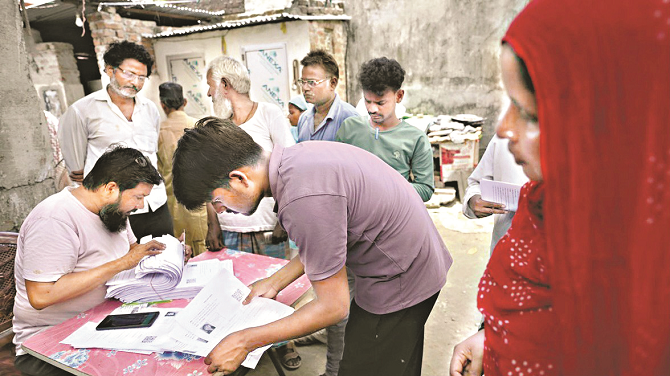 People filling forms as part of a special voter list revision campaign in Bihar. Photo: INN