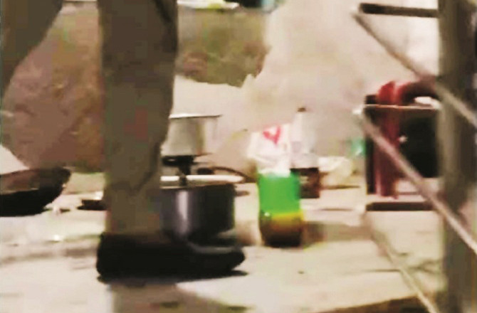 A bottle of wine and a pot in which chicken is said to have been cooked in the gym. Photo: INN