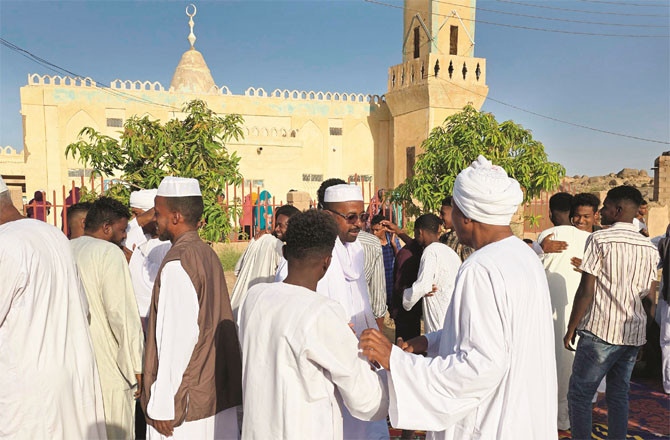 Locals congratulate each other after Eid prayers in the city of Meru, northern Sudan.