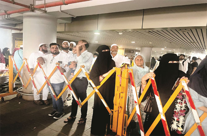 Families of pilgrims waiting for them at the airport premises.