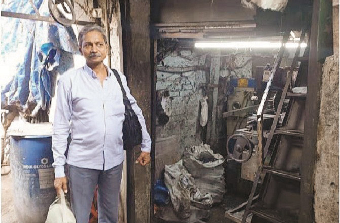 Hemant Jain stands next to the shop he bought at the auction. Photo: INN