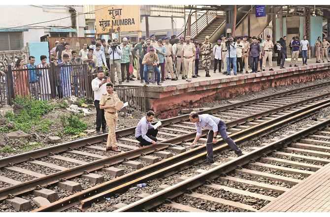 Railway police officers inspect the accident site. Photo: Syed Sameer Abadi
