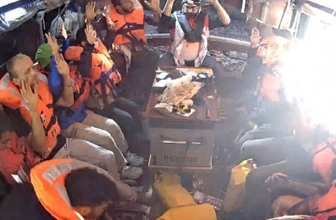 The crew on board the boat have both hands raised. Photo: X