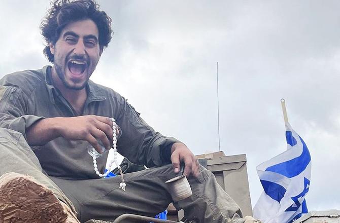 An Israeli soldier with stolen goods. Photo: X