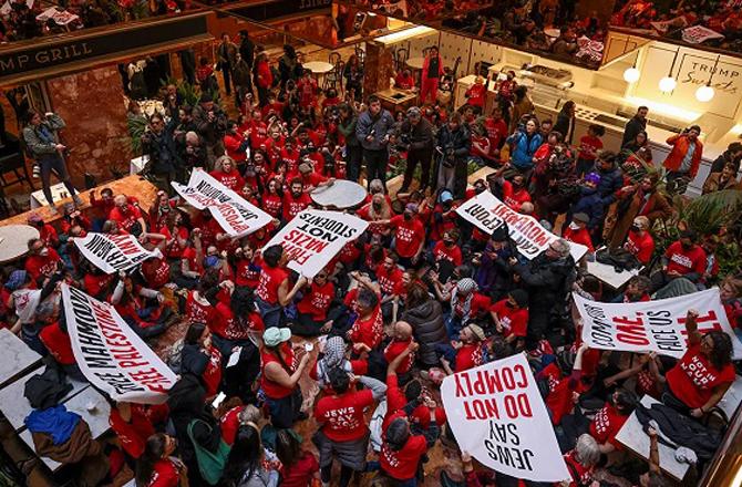 Protesters stage a massive protest in the lobby of Trump Tower. Photo: INN