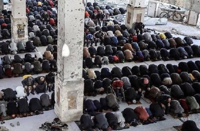 Palestinians pray in a mosque destroyed by Israeli bombing. Photo: X
