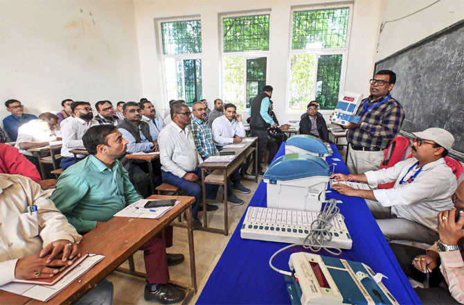 Election Commission officers explaining the procedure for counting votes to polling officers. (Photo: PTI)