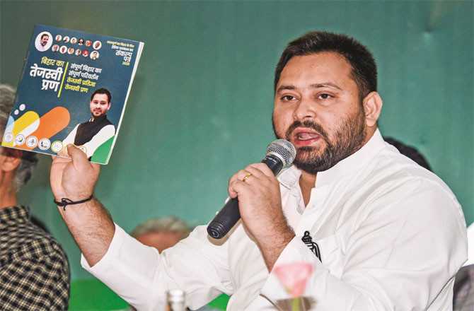 Tejashwi Yadav presenting the election manifesto of the Mahagathbandhan to the media. (PTI) Tejashwi Yadav presenting the election manifesto of the Mahagathbandhan to the media. (PTI)