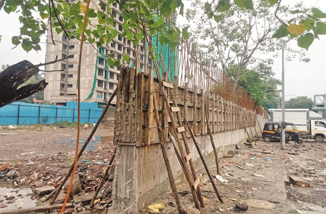 The boundary wall of the allotted land for the new cemetery, the work of which has not yet been completed.