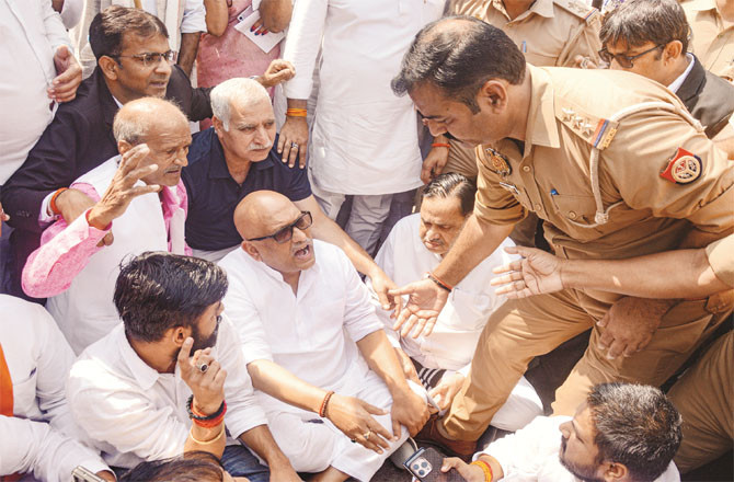 When Raje Roy and others were stopped, they sat on a dharna outside the party office. They were then taken into custody.