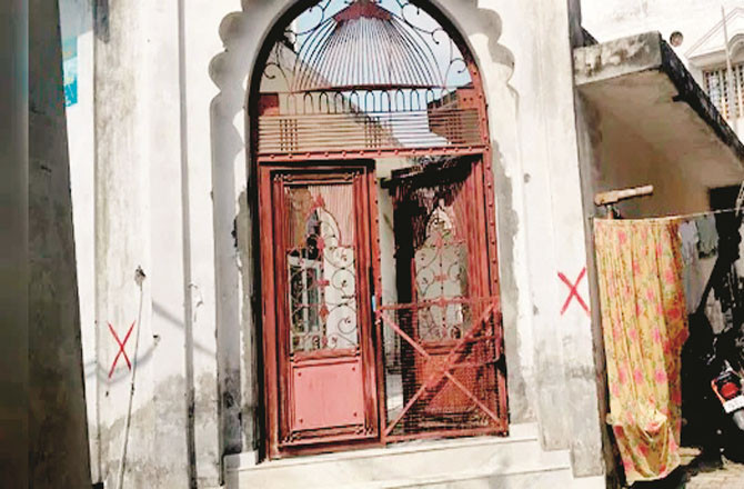 The walls of buildings in the Muslim settlement of Hatim Sarai Khurd have been marked with red paint.