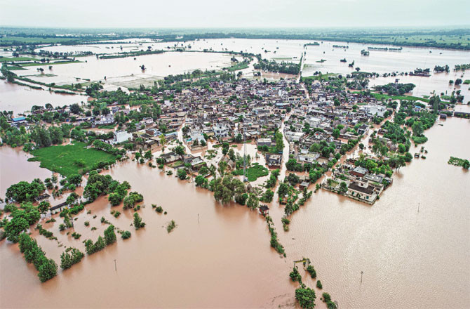 In the picture taken from a high point, the village of Gunwar in Patiala can be seen surrounded by floods from all sides.
