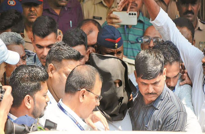 Ashok Kharat (in a mask) being led away from the court (Photo: Agency)