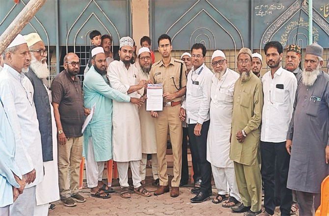 Protesters handing a memorandum to a police officer