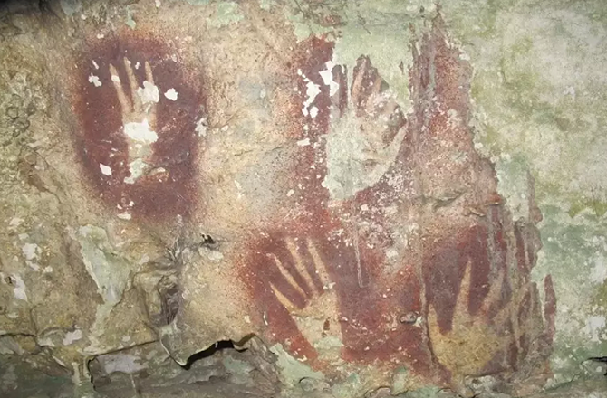 Handprints can be seen in a cave in Sulawesi. Photo: INN
