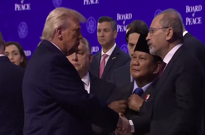 Trump shaking hands with attendees after signing the Board of Trustees. Photo: X