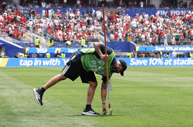 Ground staff inspecting the pitch. Photo: INN