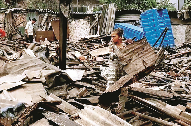 A Girl Is Picking Up Leaves From The Rubble Of The Destroyed Huts.Photo:INN