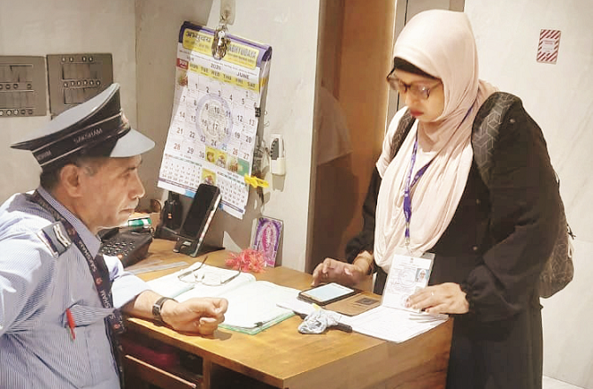 A teacher is seen busy with the census