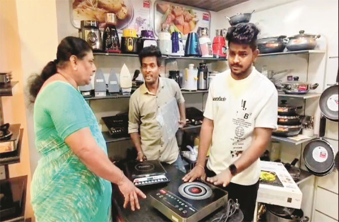 A woman buys an electric stove from a shop in Kalyan.