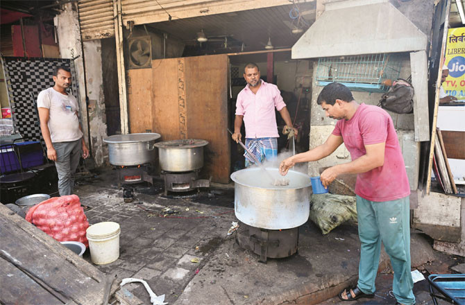 Hotel employees are cooking on a stove due to the lack of gas cylinders.