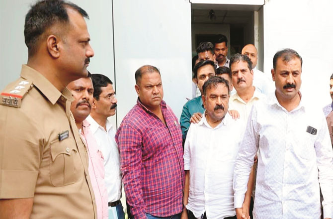 Ashok Kharat (second from left) in police custody (Agency)