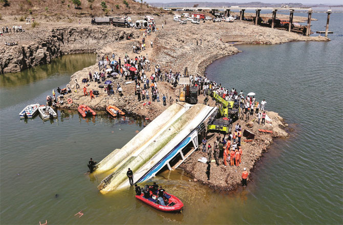 Rescue personnel can be seen near the stricken cruise ship.