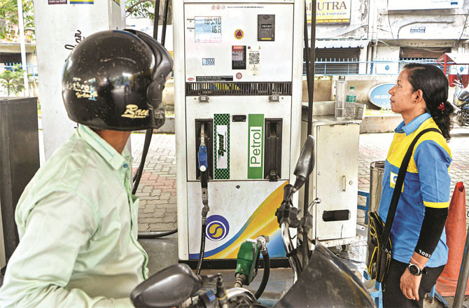 A motorcyclist looks at the meter at a petrol pump in Siliguri, West Bengal. (PTI)
