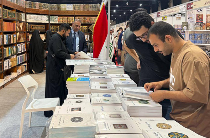 A man looks at books on a stall at the Baghdad Book Fair. Photo: X